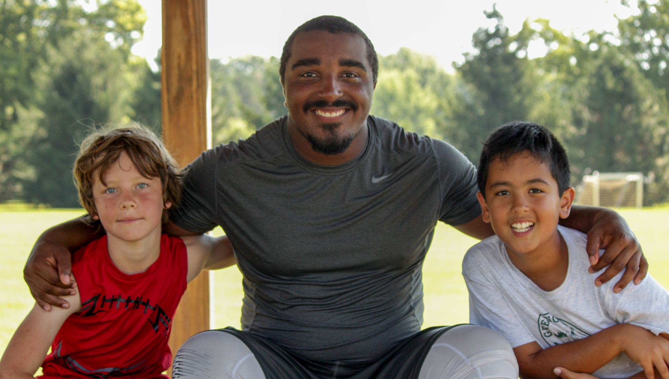 Jordan sitting with two campers