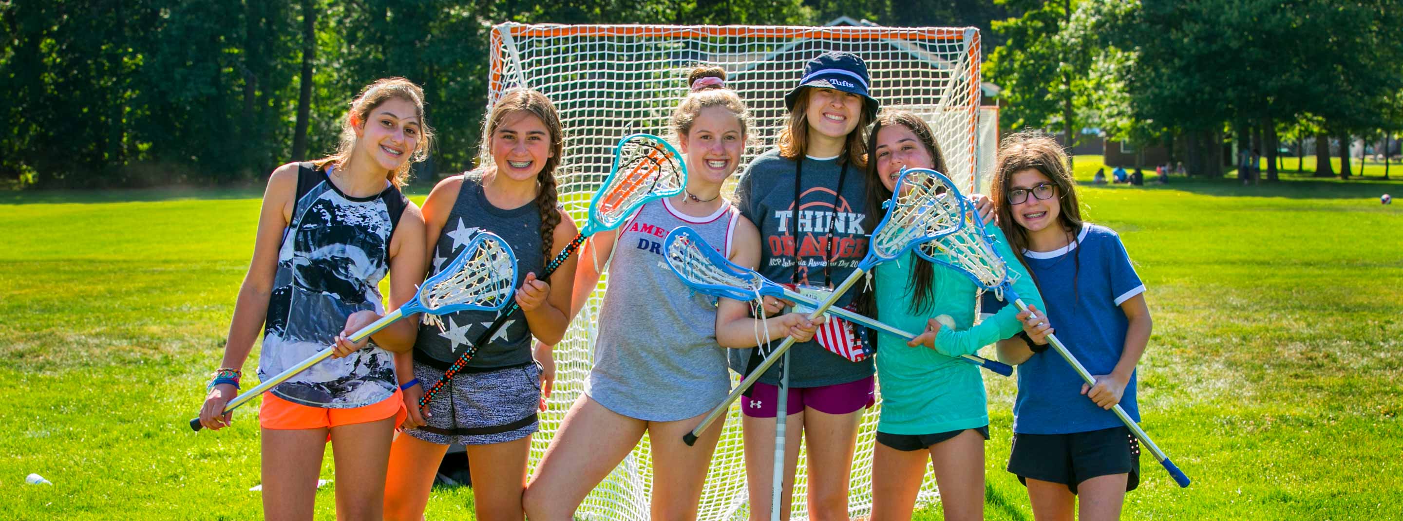 Girls with lacrosse sticks on field